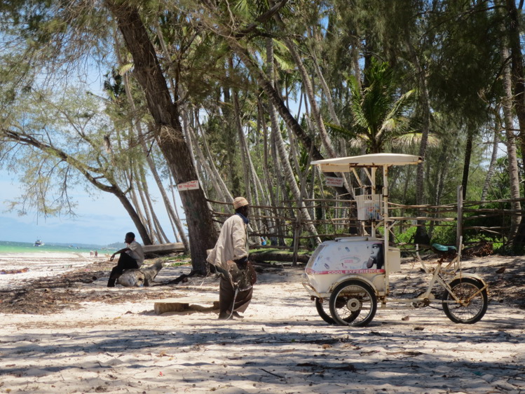 A tropical beach with locals in Kenya